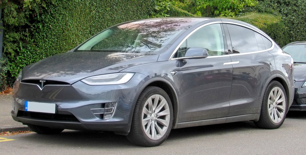 A Tesla Model X SUV with its falcon-wing door raised