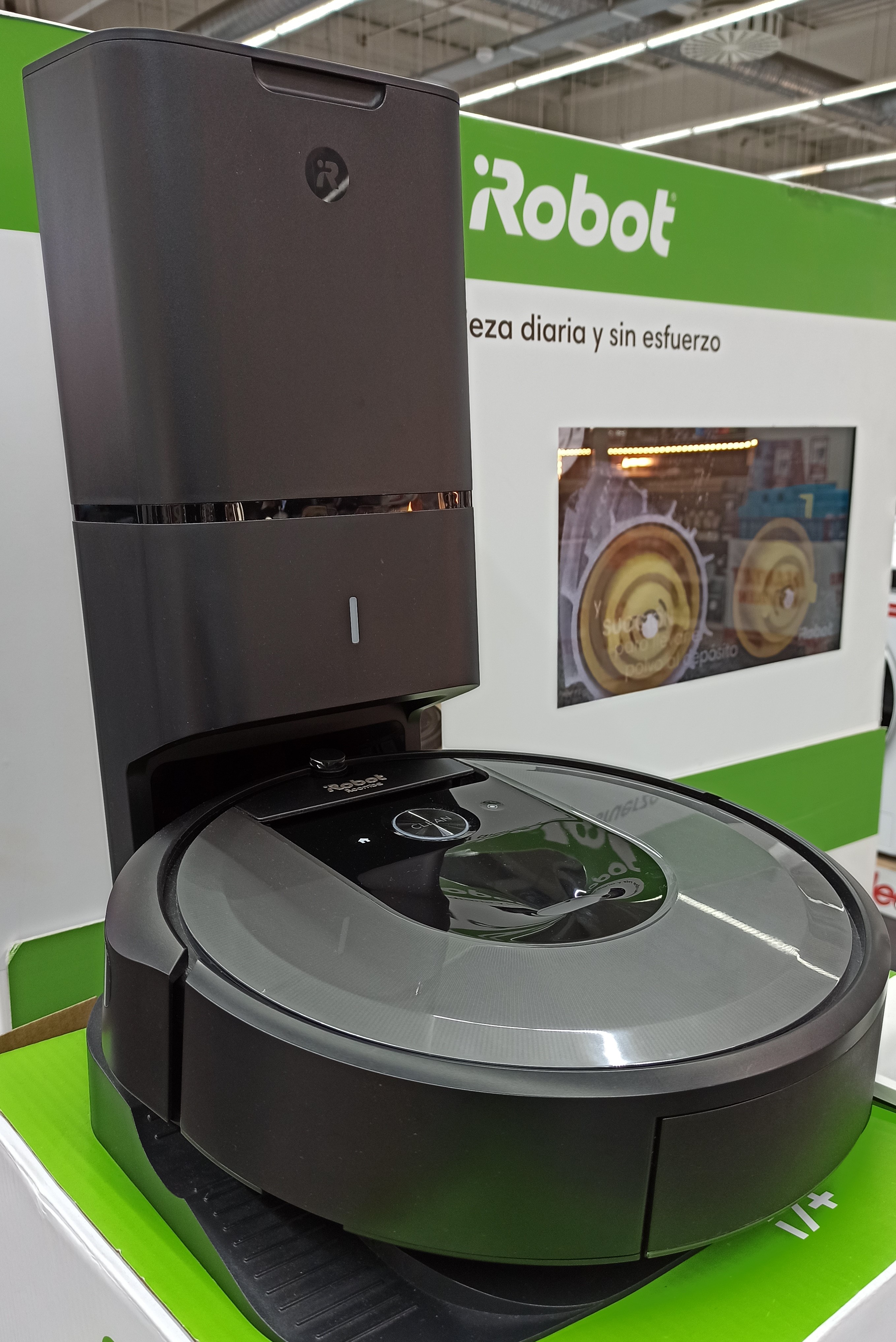 An iRobot Roomba i7+ robot vacuum on its charging and dirt-disposal base