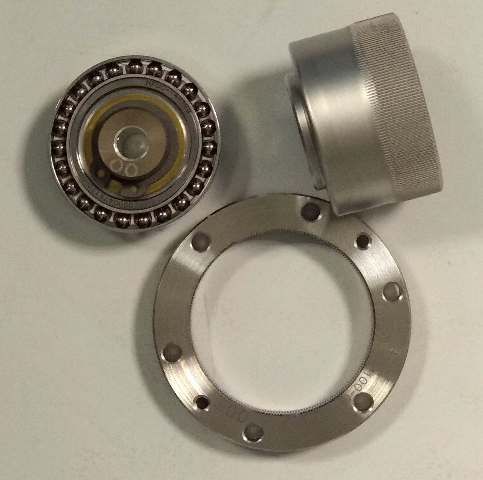 The components of a strain wave (harmonic drive) gear set laid out separately