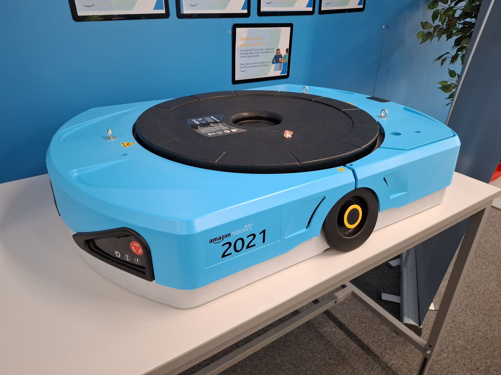 An Amazon Robotics drive-unit robot carrying a shelving pod at a fulfillment center
