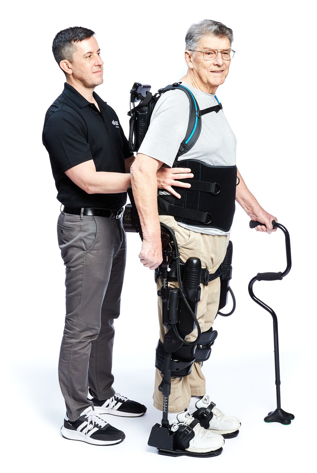 A patient walking with an Ekso Bionics EksoNR rehabilitation exoskeleton, assisted by a therapist