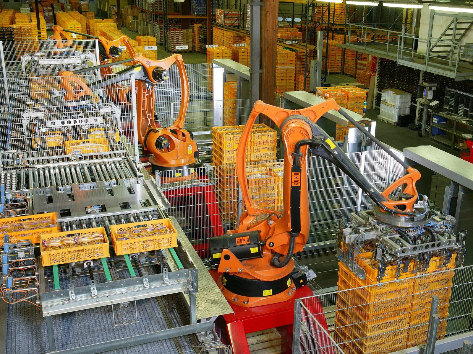 Industrial robot arms palletizing bread on a factory production line